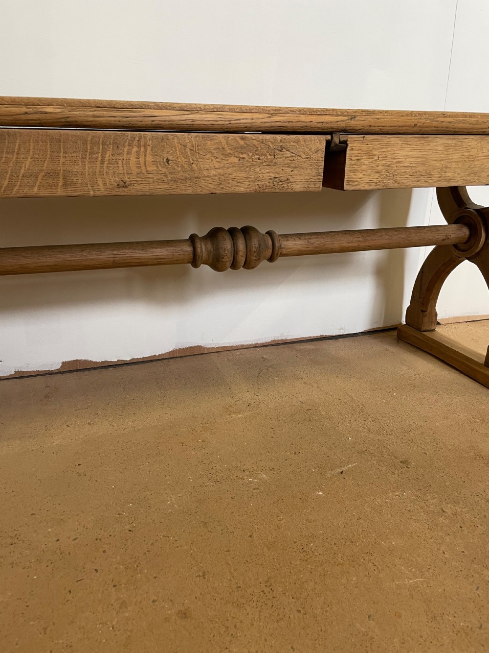 A Victorian oak window seat featuring arched Gothic Revival end legs, two frieze drawers, and a central turned stretcher. View III