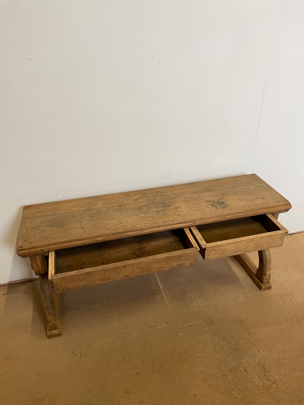 A Victorian oak window seat featuring arched Gothic Revival end legs, two frieze drawers, and a central turned stretcher. View IX