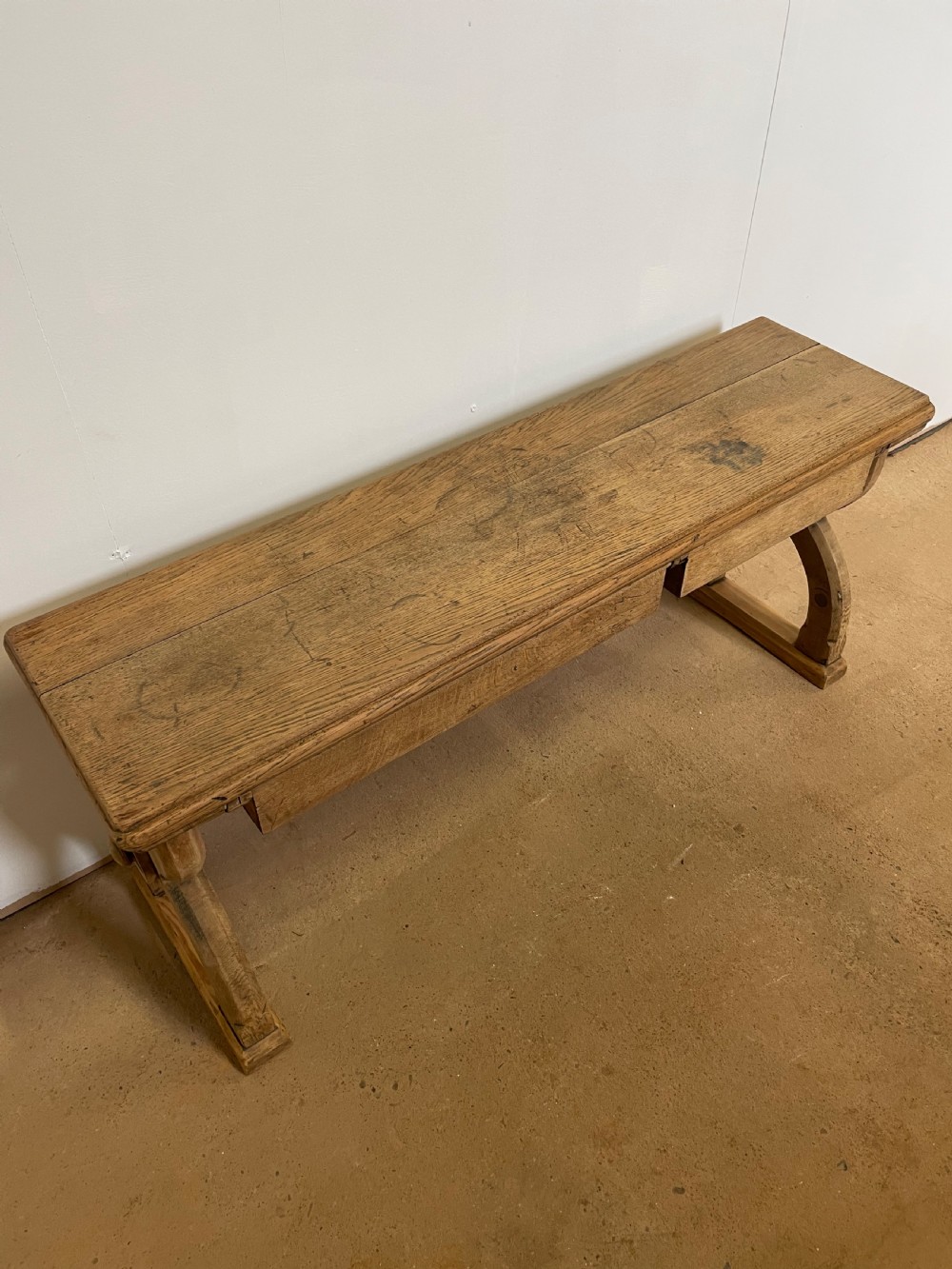 A Victorian oak window seat featuring arched Gothic Revival end legs, two frieze drawers, and a central turned stretcher. View XI