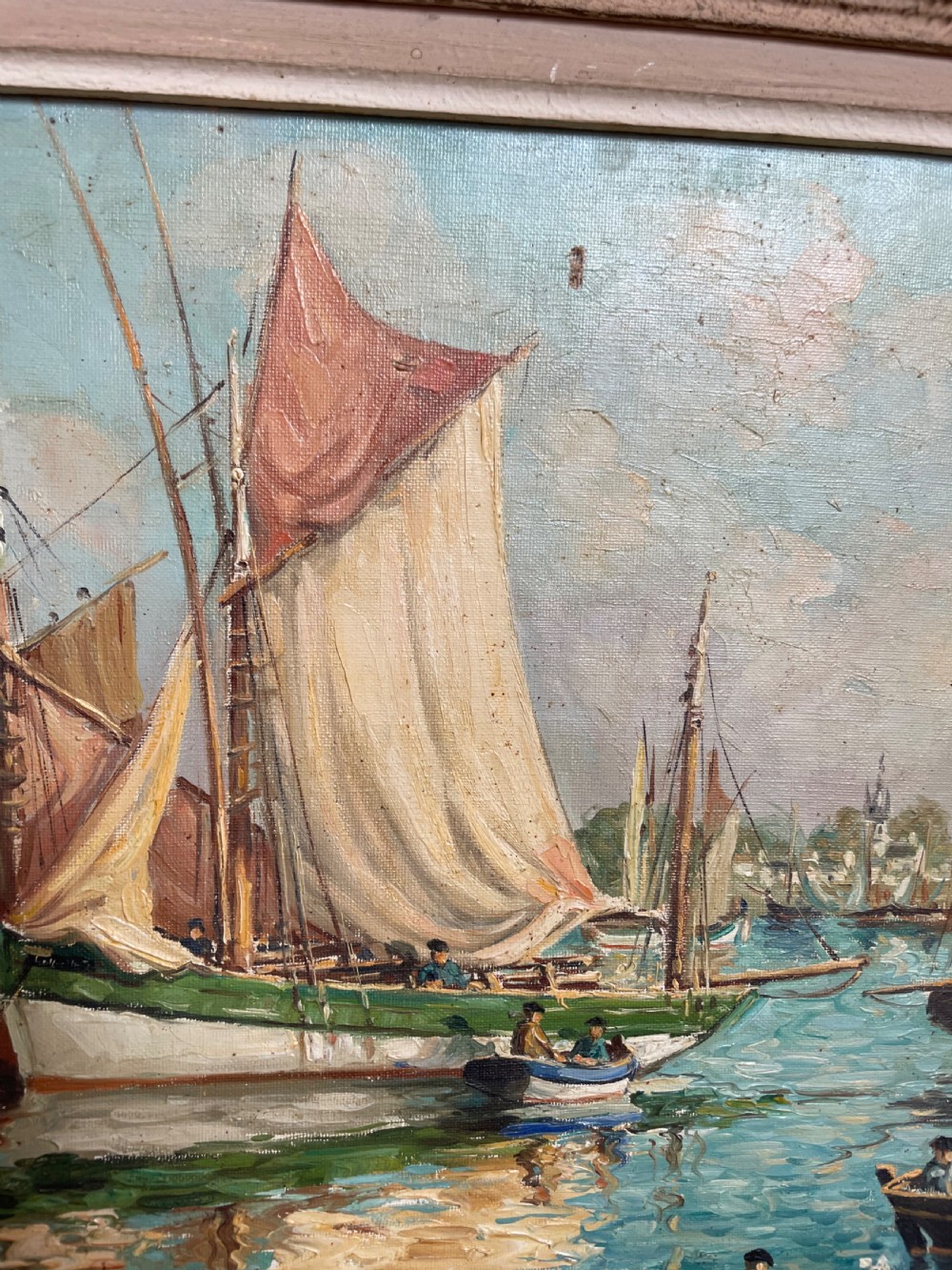 An oil painting on canvas depicting traditional fishing boats docked in a harbour alongside figures on a stone quay, enclosed in a carved wooden frame. View VII