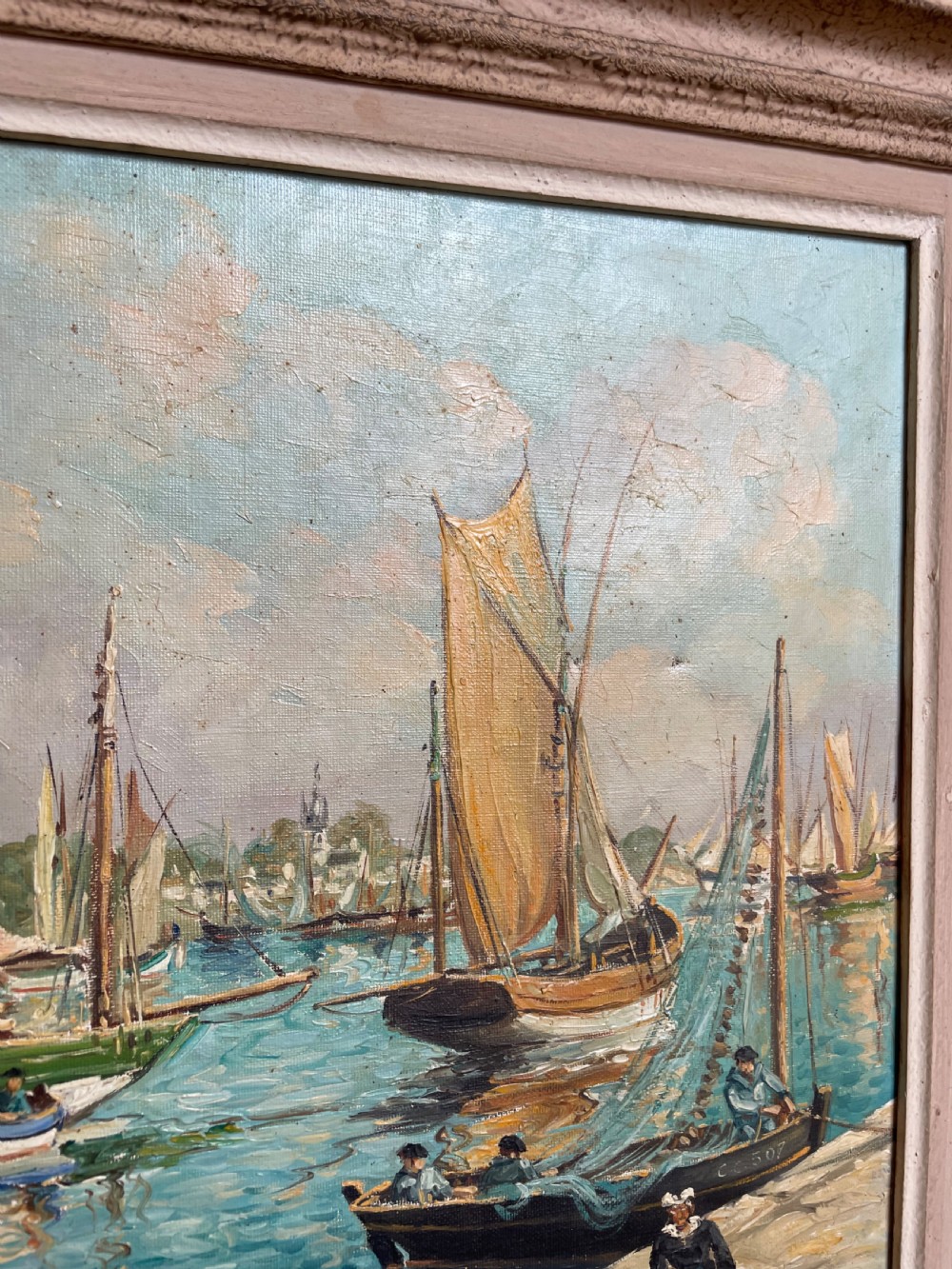 An oil painting on canvas depicting traditional fishing boats docked in a harbour alongside figures on a stone quay, enclosed in a carved wooden frame. View VIII
