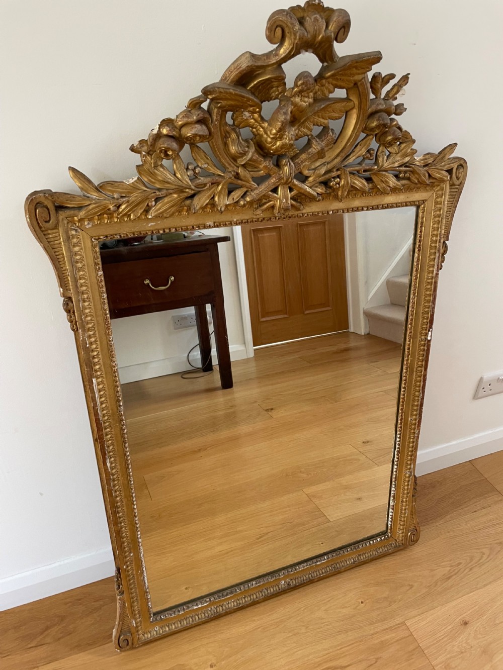 Gilt mirror, with ornate cresting 