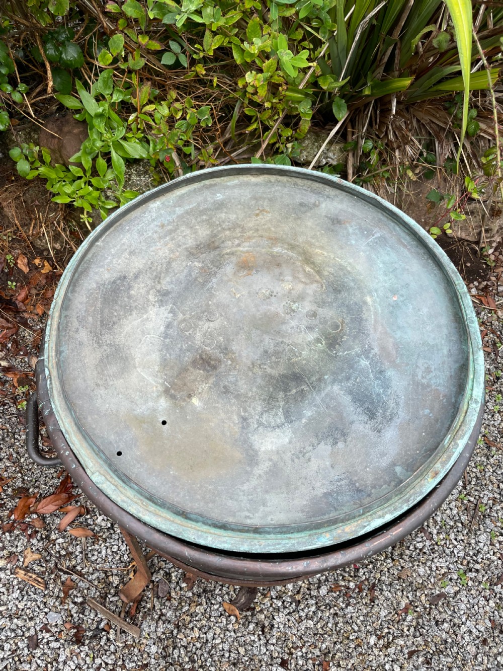 A large lidded copper log bin featuring riveted side handles, a flat lid with a central handle, and a raised iron support stand. View II