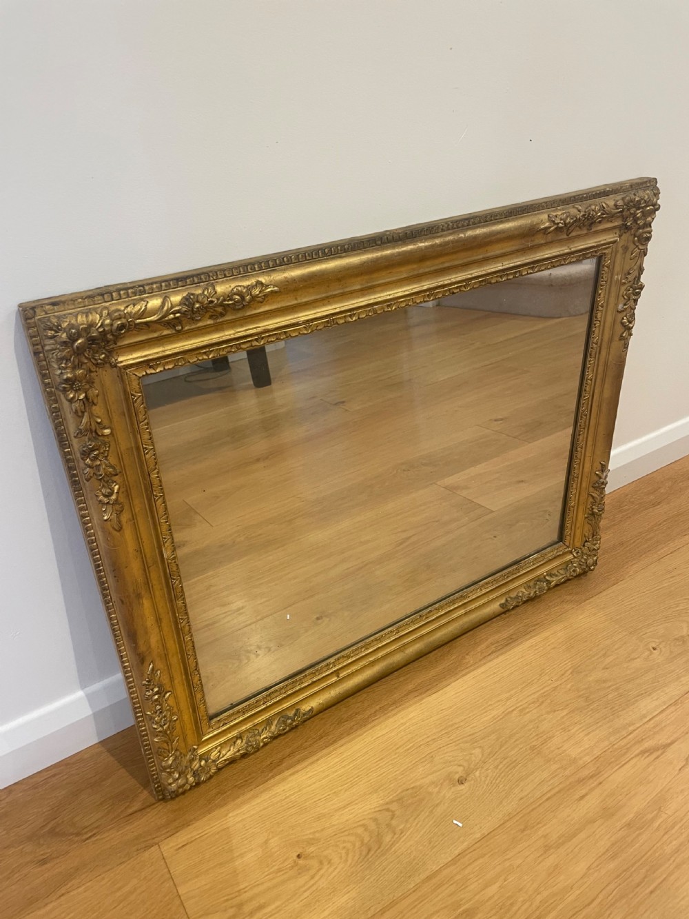 Small antique gilt mirror with floral decoration 