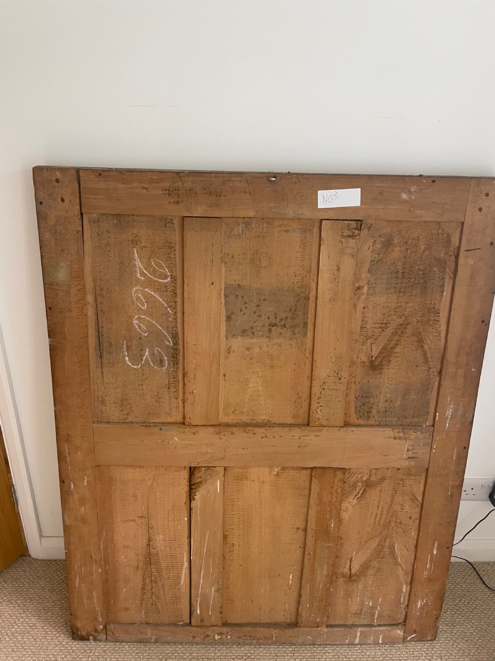 A large rectangular antique overmantel mirror featuring a gilded frame embellished with gesso scrollwork, floral motifs, and a central cartouche top emblem. View X