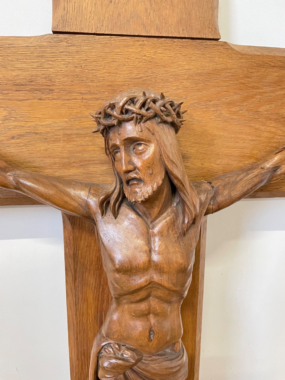A large Art Deco style carved oak crucifix featuring a detailed wooden figure of Jesus Christ mounted on a broad-armed cross. View II