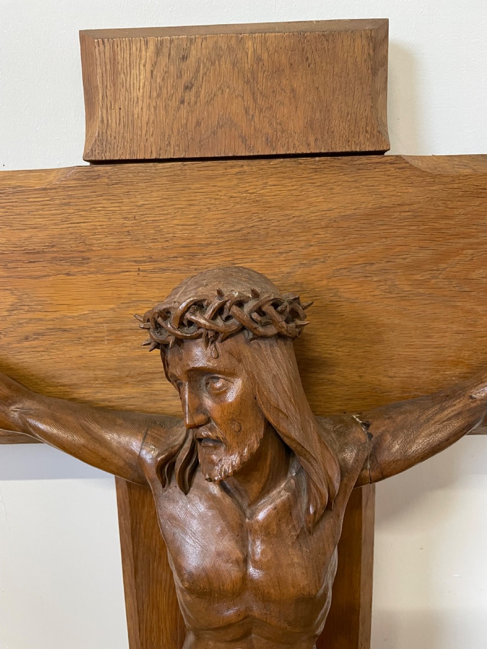 A large Art Deco style carved oak crucifix featuring a detailed wooden figure of Jesus Christ mounted on a broad-armed cross. View VII