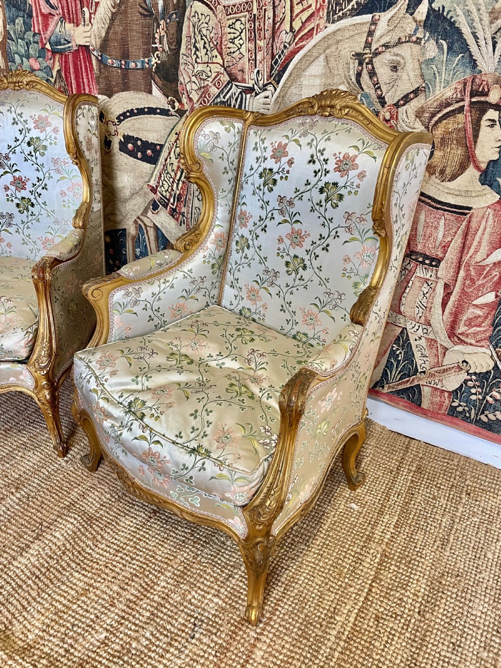 A pair of carved gilt wood fauteuil armchairs upholstered in patterned floral silk fabric. View II