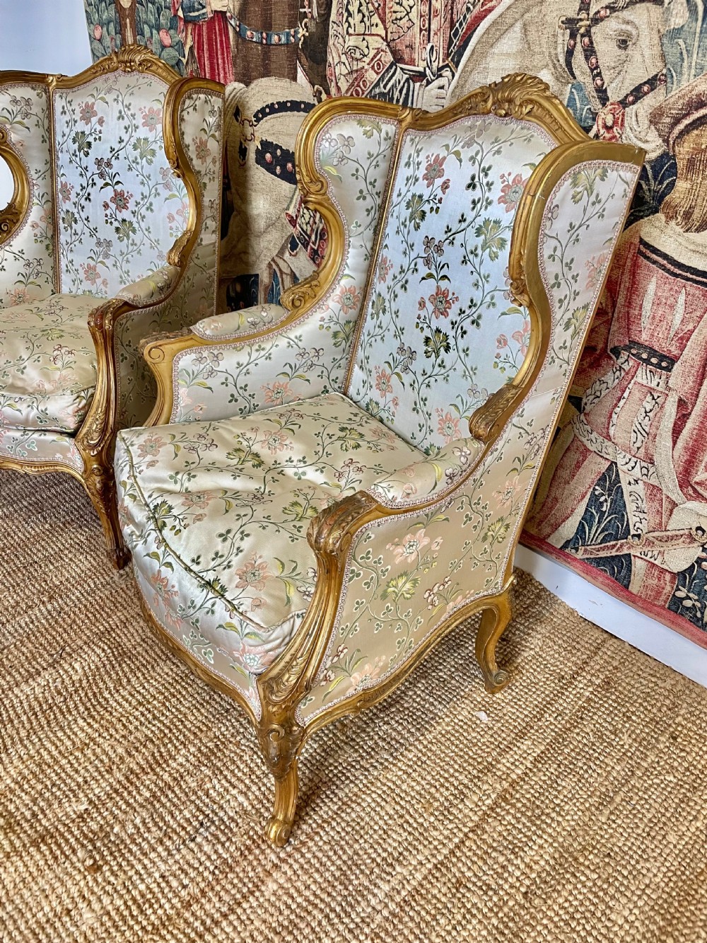 A pair of carved gilt wood fauteuil armchairs upholstered in patterned floral silk fabric. View III