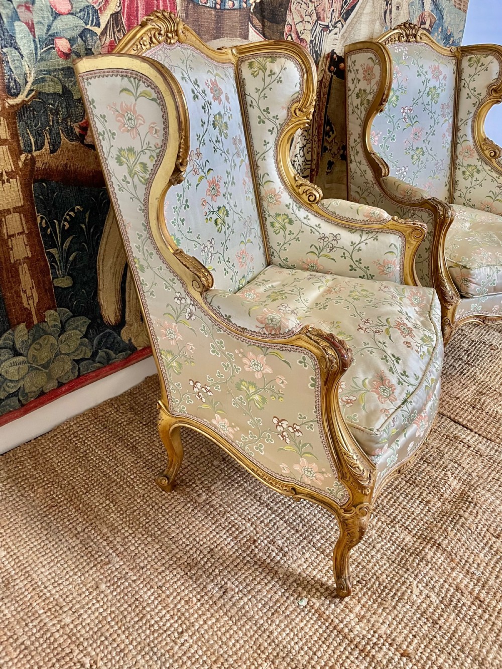 A pair of carved gilt wood fauteuil armchairs upholstered in patterned floral silk fabric. View IV