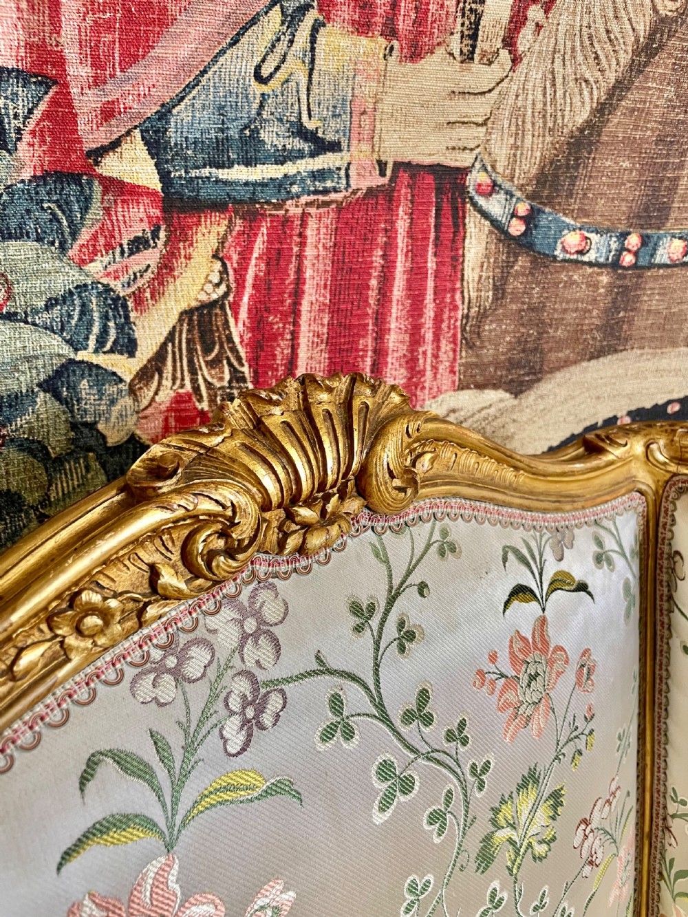 A pair of carved gilt wood fauteuil armchairs upholstered in patterned floral silk fabric. View VI