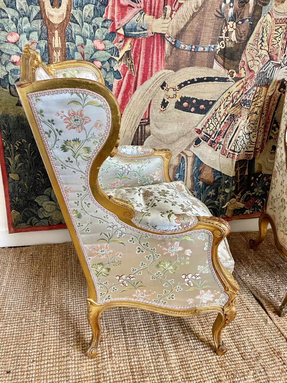 A pair of carved gilt wood fauteuil armchairs upholstered in patterned floral silk fabric. View VII