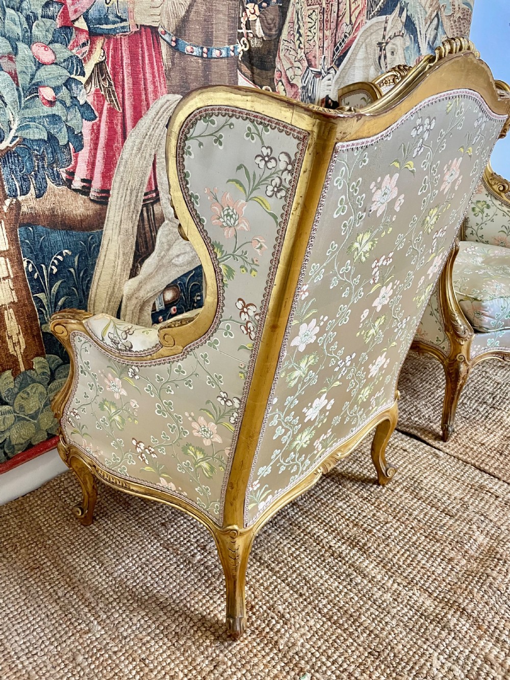 A pair of carved gilt wood fauteuil armchairs upholstered in patterned floral silk fabric. View IX