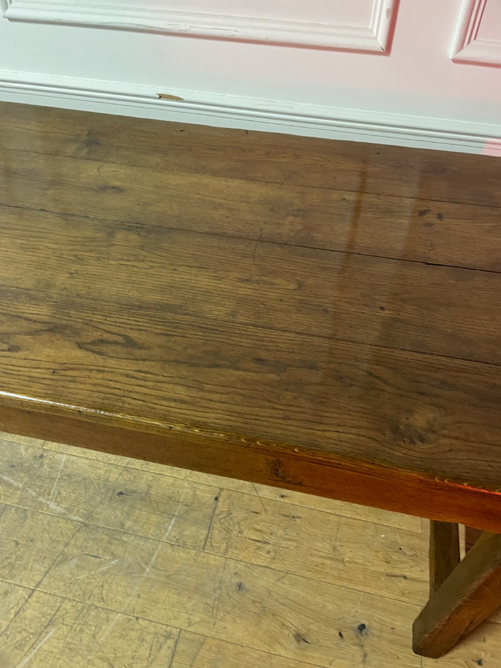 A long, antique oak farmhouse dining table featuring a planked timber top and straight wooden legs joined by side stretchers. View VI