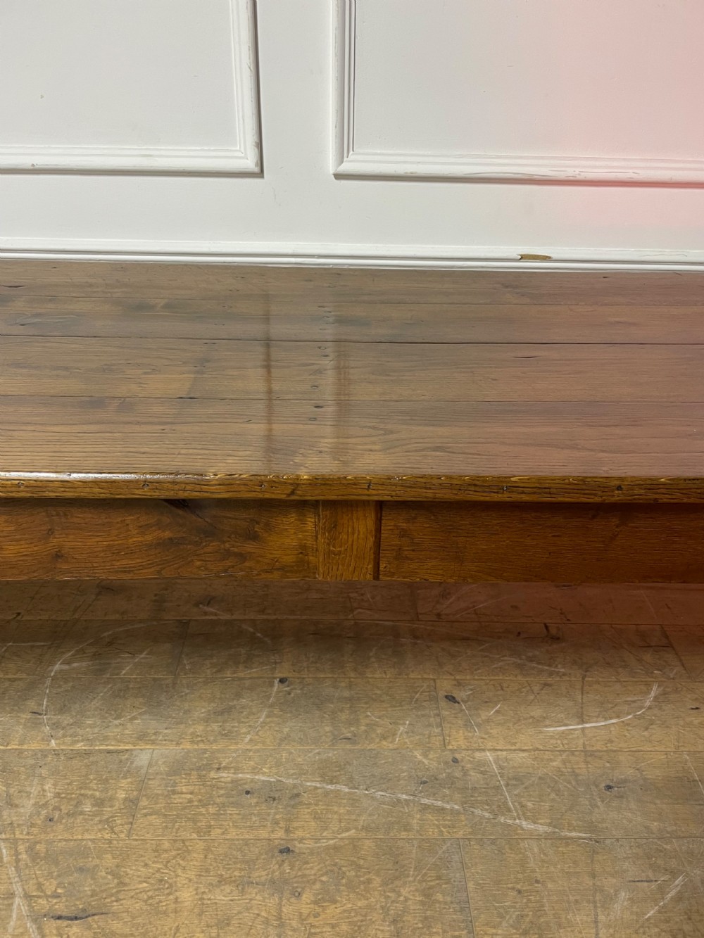 A long, antique oak farmhouse dining table featuring a planked timber top and straight wooden legs joined by side stretchers. View IX