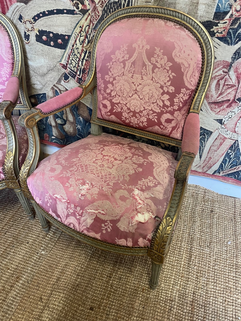 A pair of antique French fauteuils featuring carved gilt frames and pink patterned silk upholstery. View II