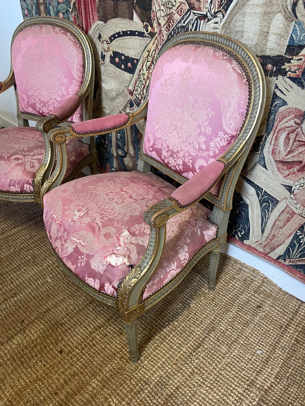 A pair of antique French fauteuils featuring carved gilt frames and pink patterned silk upholstery. View III