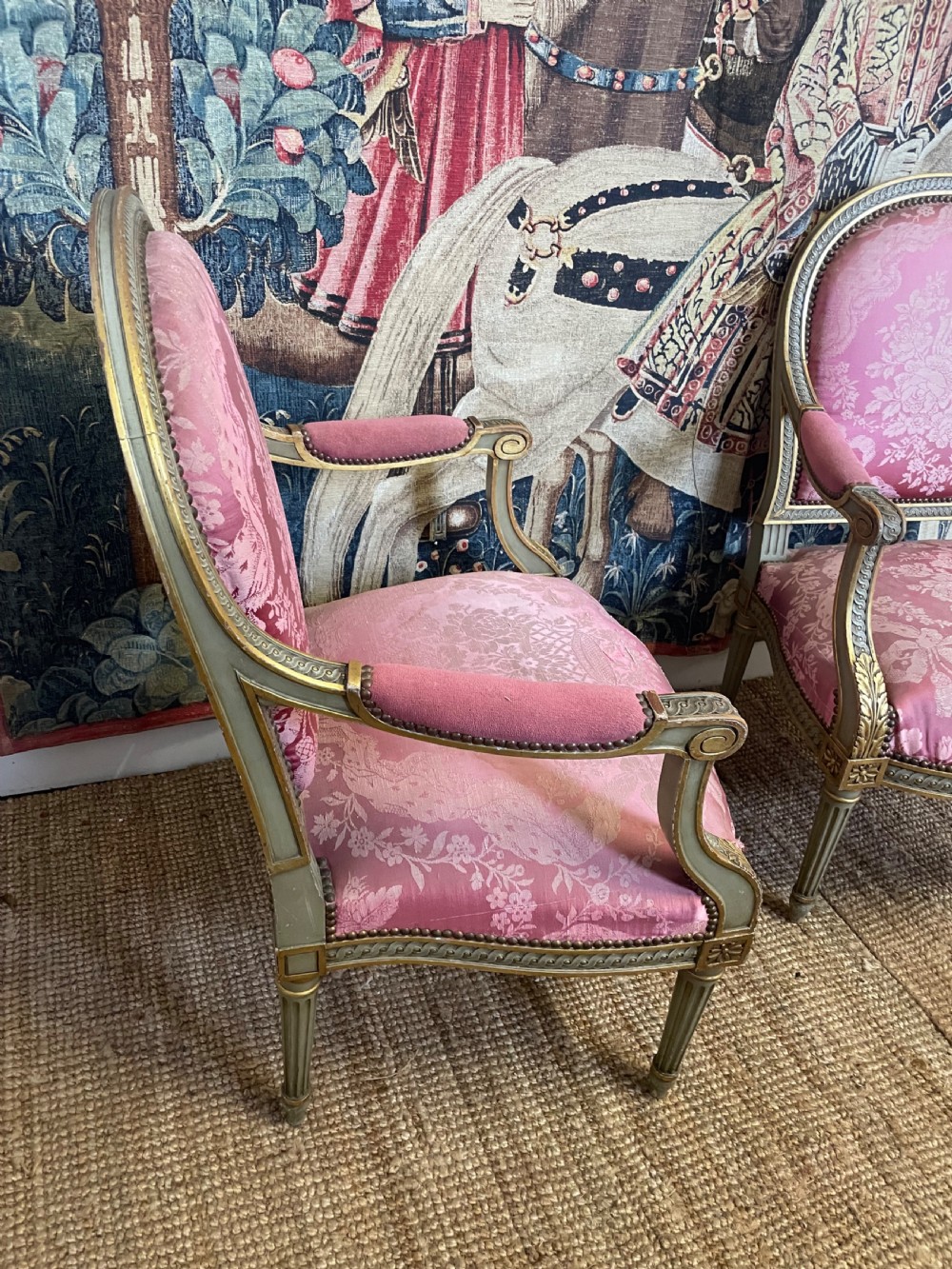 A pair of antique French fauteuils featuring carved gilt frames and pink patterned silk upholstery. View VII