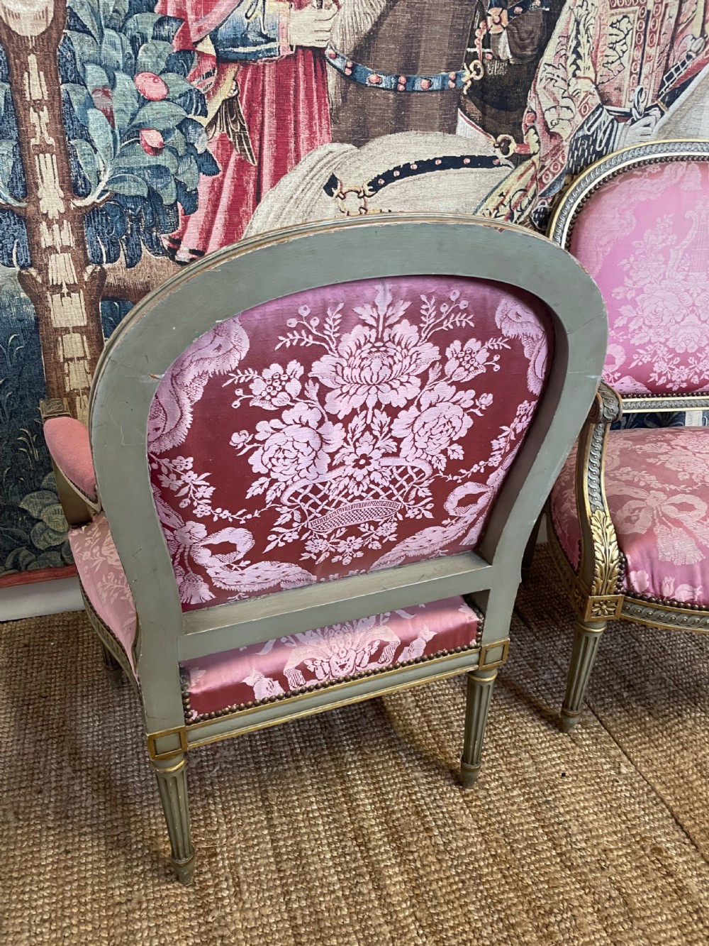 A pair of antique French fauteuils featuring carved gilt frames and pink patterned silk upholstery. View VIII