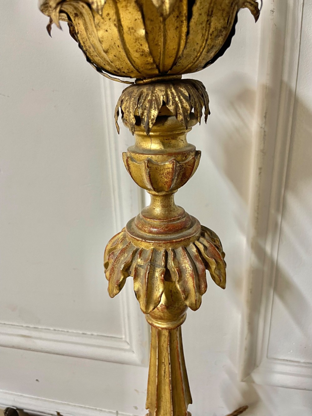 A tall Italian giltwood table lamp styled as a candlestick with acanthus leaf carvings, a fluted stem, and a faux candle sleeve. View V