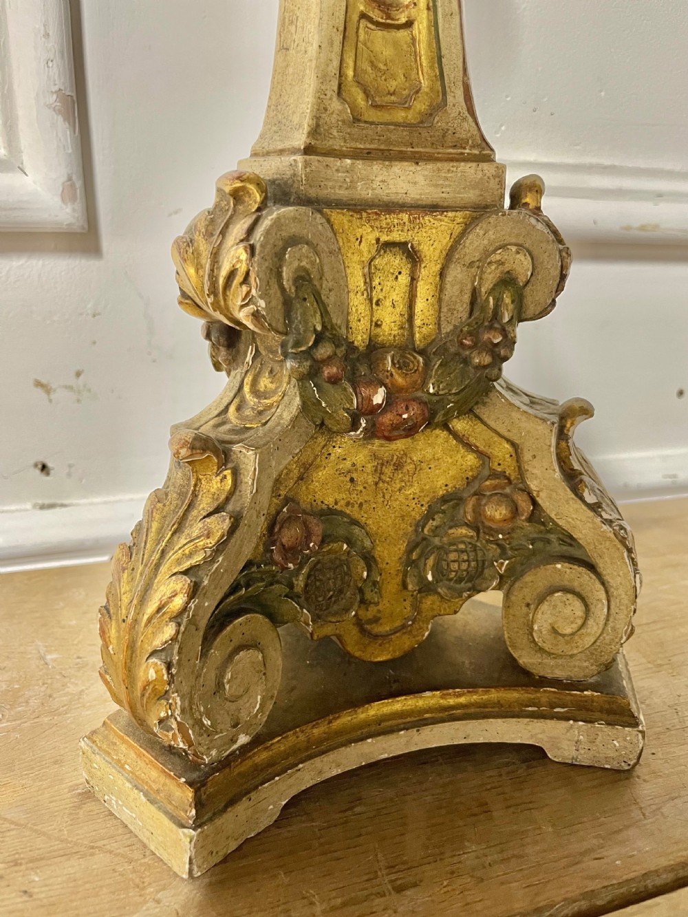 A tall, carved giltwood and cream painted table lamp base featuring neoclassical scrollwork and floral swags. View IV