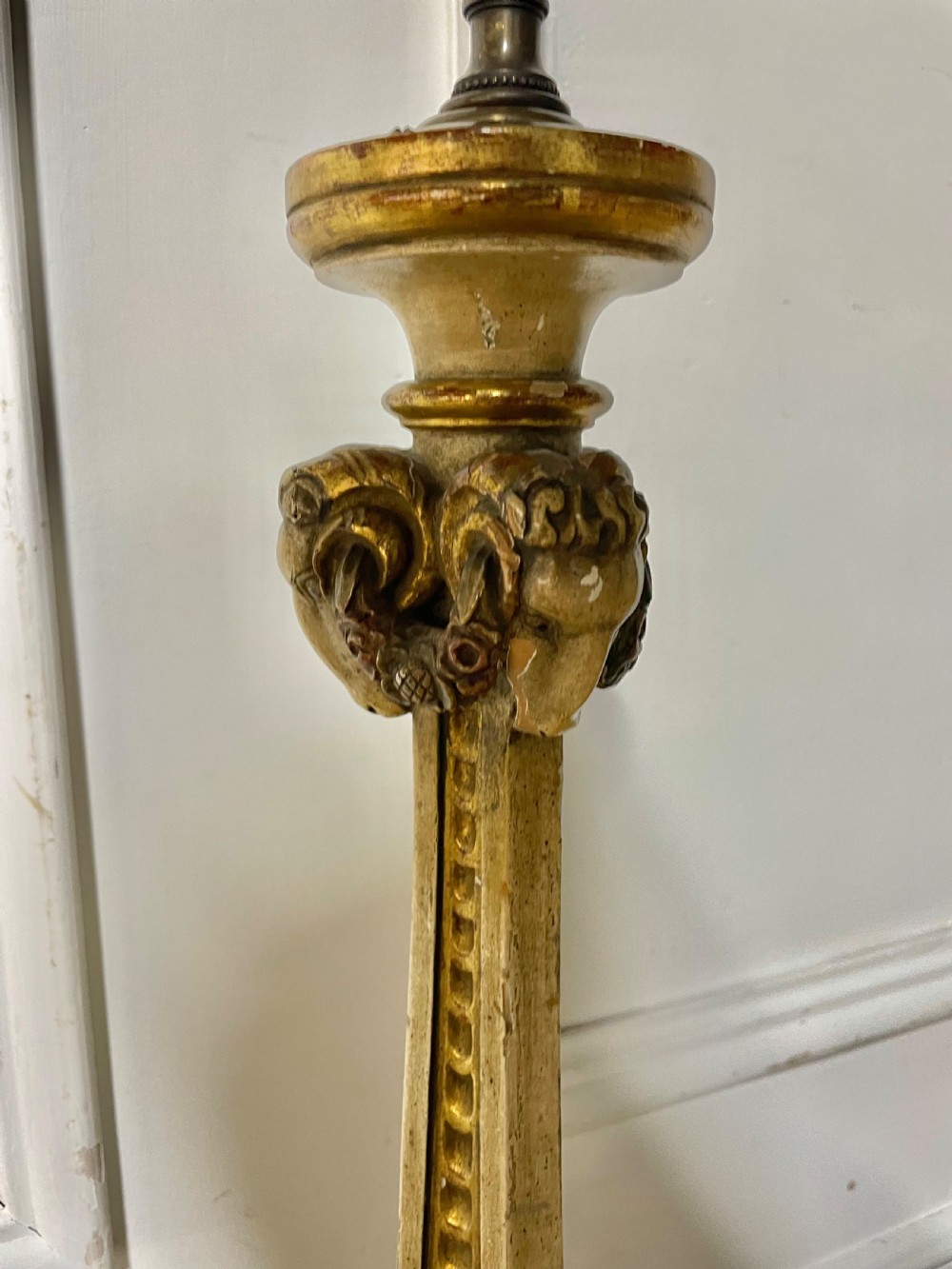 A tall, carved giltwood and cream painted table lamp base featuring neoclassical scrollwork and floral swags. View VI