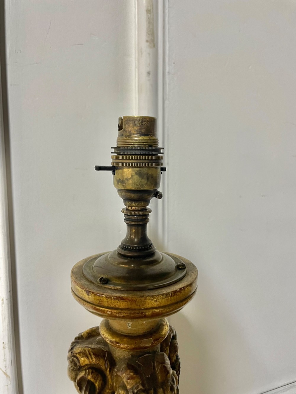 A tall, carved giltwood and cream painted table lamp base featuring neoclassical scrollwork and floral swags. View VII