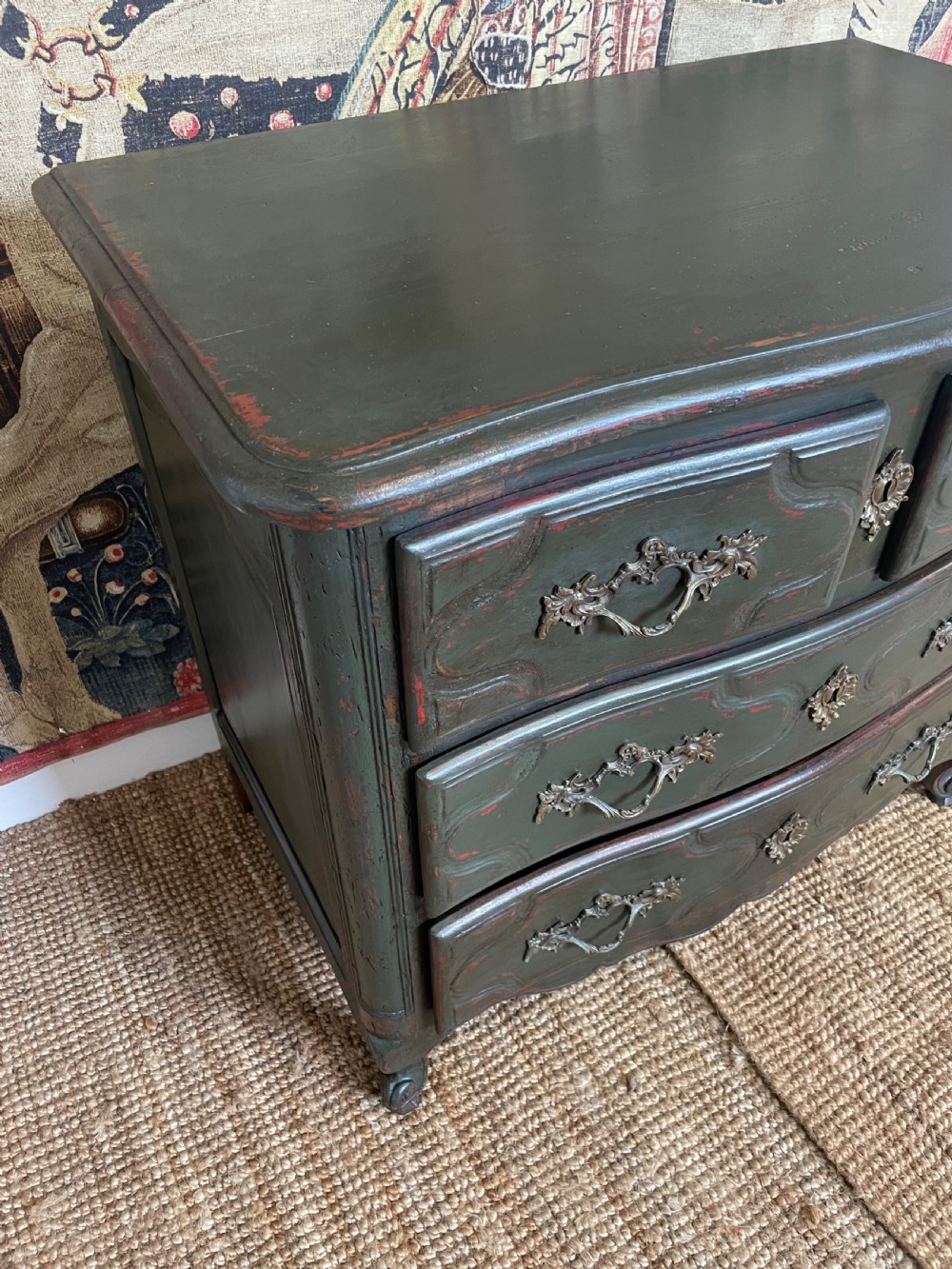 A dark green painted French commode chest of drawers featuring moulded panels, distressed finish, and decorative brass handles. View III