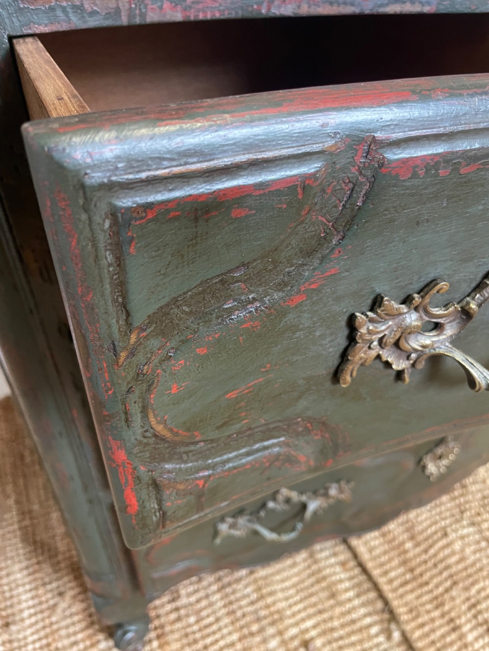 A dark green painted French commode chest of drawers featuring moulded panels, distressed finish, and decorative brass handles. View VIII