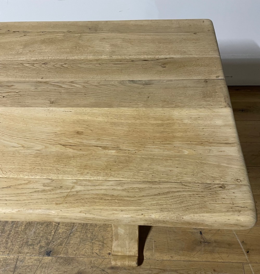 A long rectangular scrubbed oak refectory table featuring turned pedestal supports and a central stretcher. View III