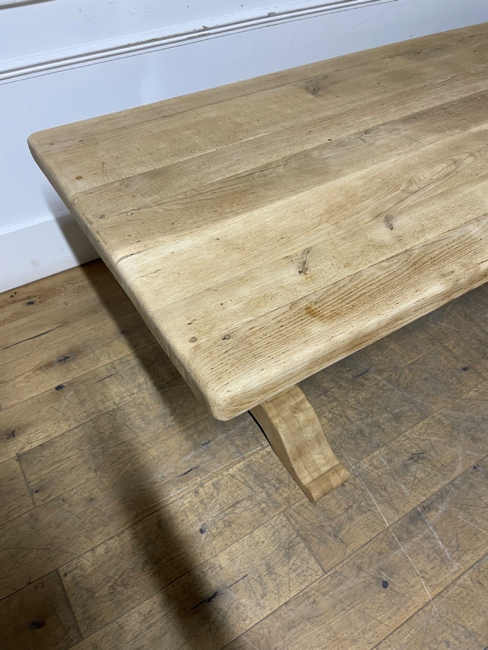 A long rectangular scrubbed oak refectory table featuring turned pedestal supports and a central stretcher. View VI