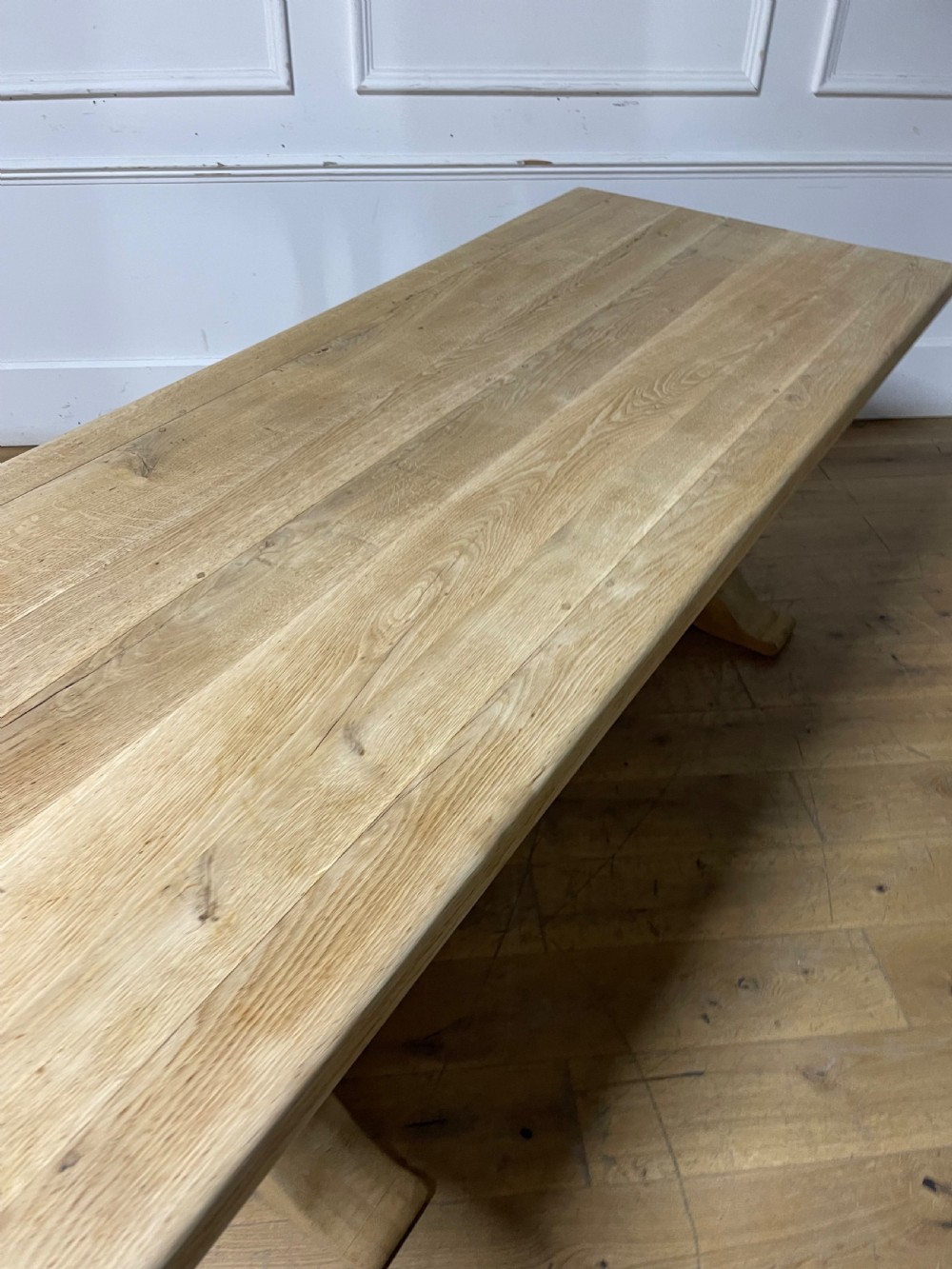 A long rectangular scrubbed oak refectory table featuring turned pedestal supports and a central stretcher. View XII