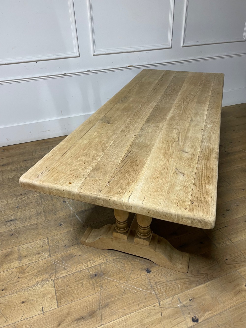 A long rectangular scrubbed oak refectory table featuring turned pedestal supports and a central stretcher. View XIV