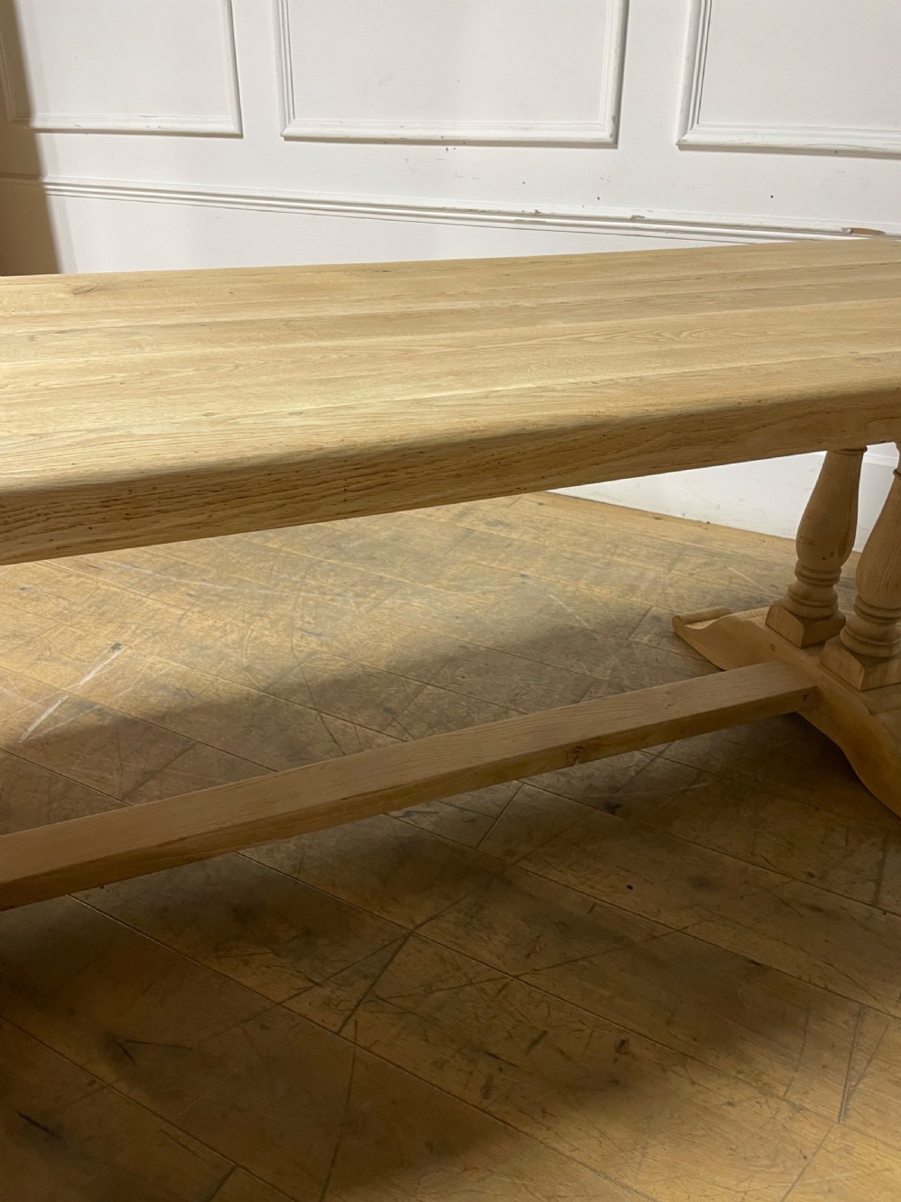 A long rectangular scrubbed oak refectory table featuring turned pedestal supports and a central stretcher. View XV