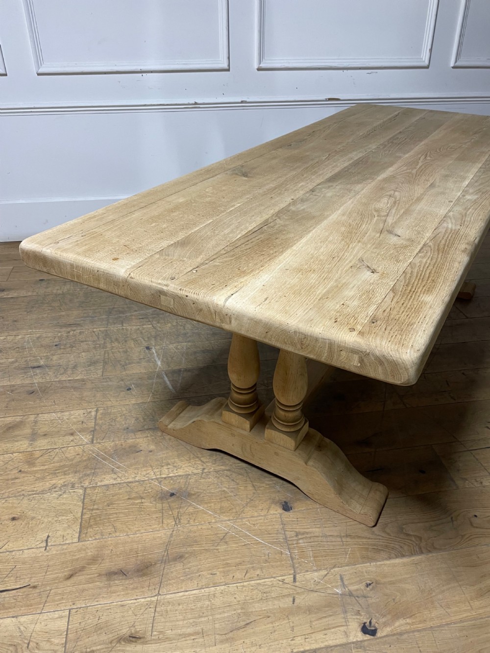 A long rectangular scrubbed oak refectory table featuring turned pedestal supports and a central stretcher. View XVI