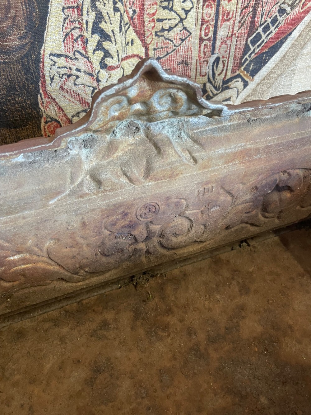 A rectangular cast iron planter trough featuring ornate relief scrollwork, foliate motifs, and a weathered rust patina. View VI