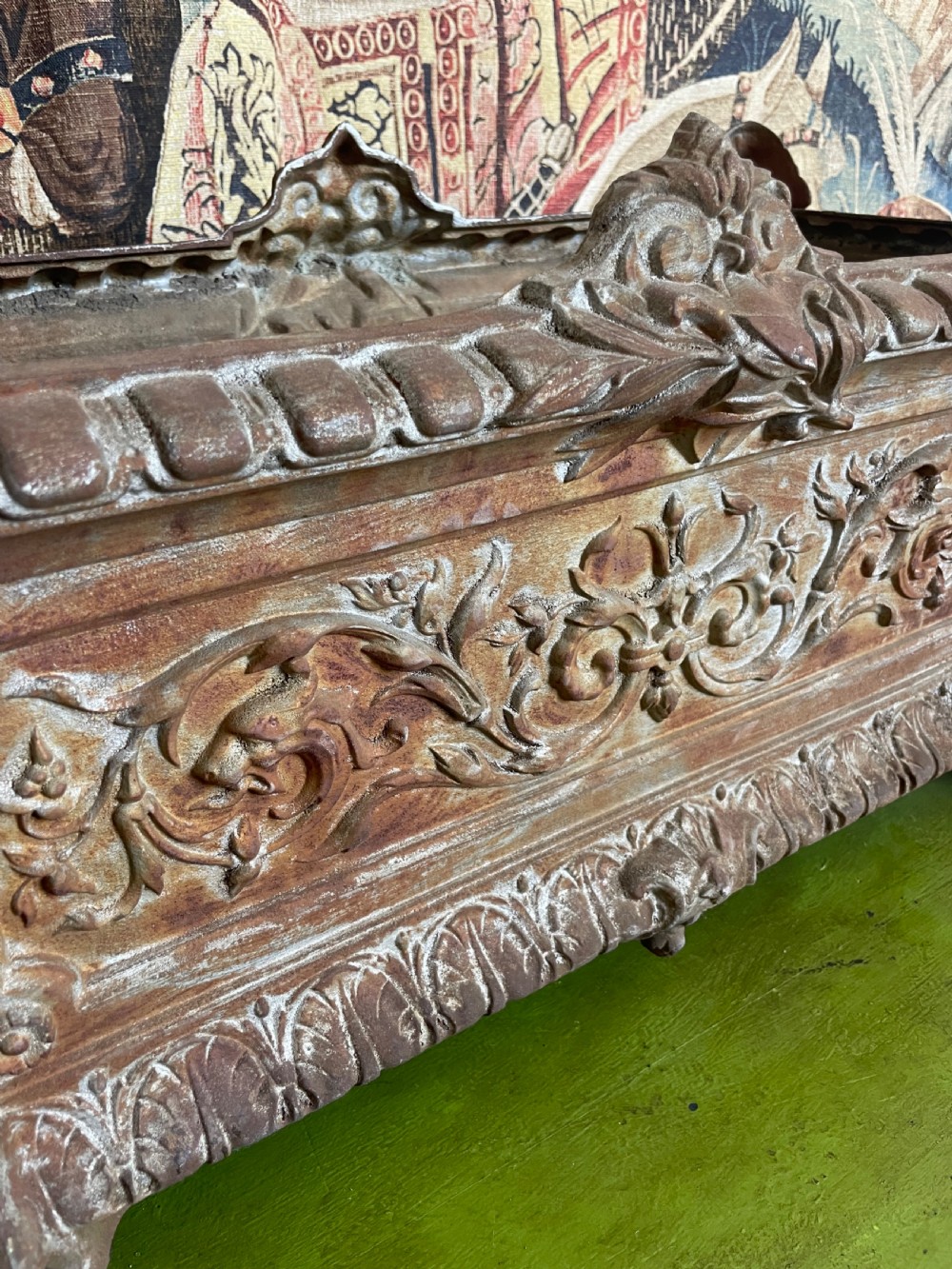 A rectangular cast iron planter trough featuring ornate relief scrollwork, foliate motifs, and a weathered rust patina. View IX