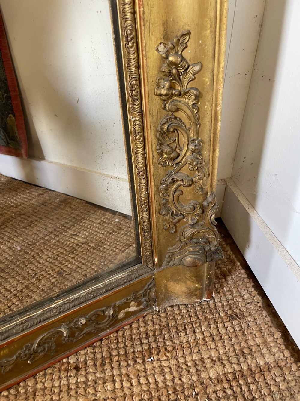 A large early 19th-century rectangular overmantle mirror with a detailed gold leaf frame featuring carved acanthus motifs and a central crest. View VII