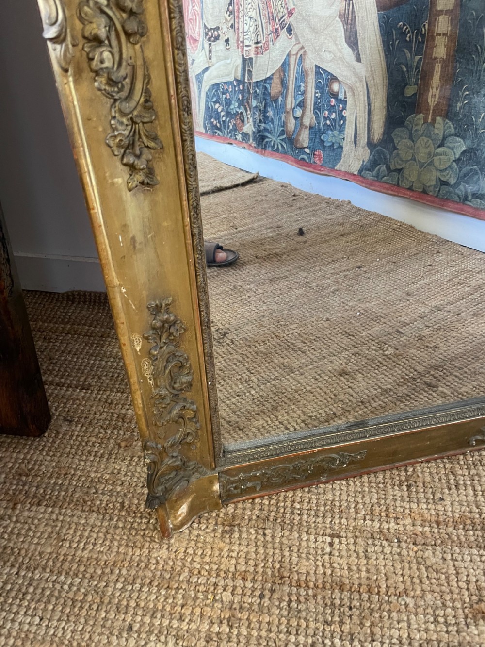 A large early 19th-century rectangular overmantle mirror with a detailed gold leaf frame featuring carved acanthus motifs and a central crest. View IX