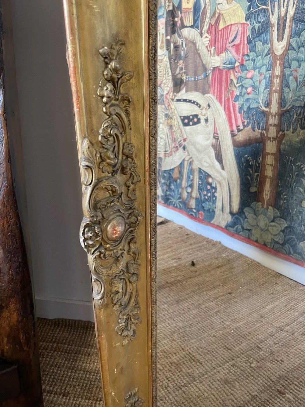 A large early 19th-century rectangular overmantle mirror with a detailed gold leaf frame featuring carved acanthus motifs and a central crest. View X