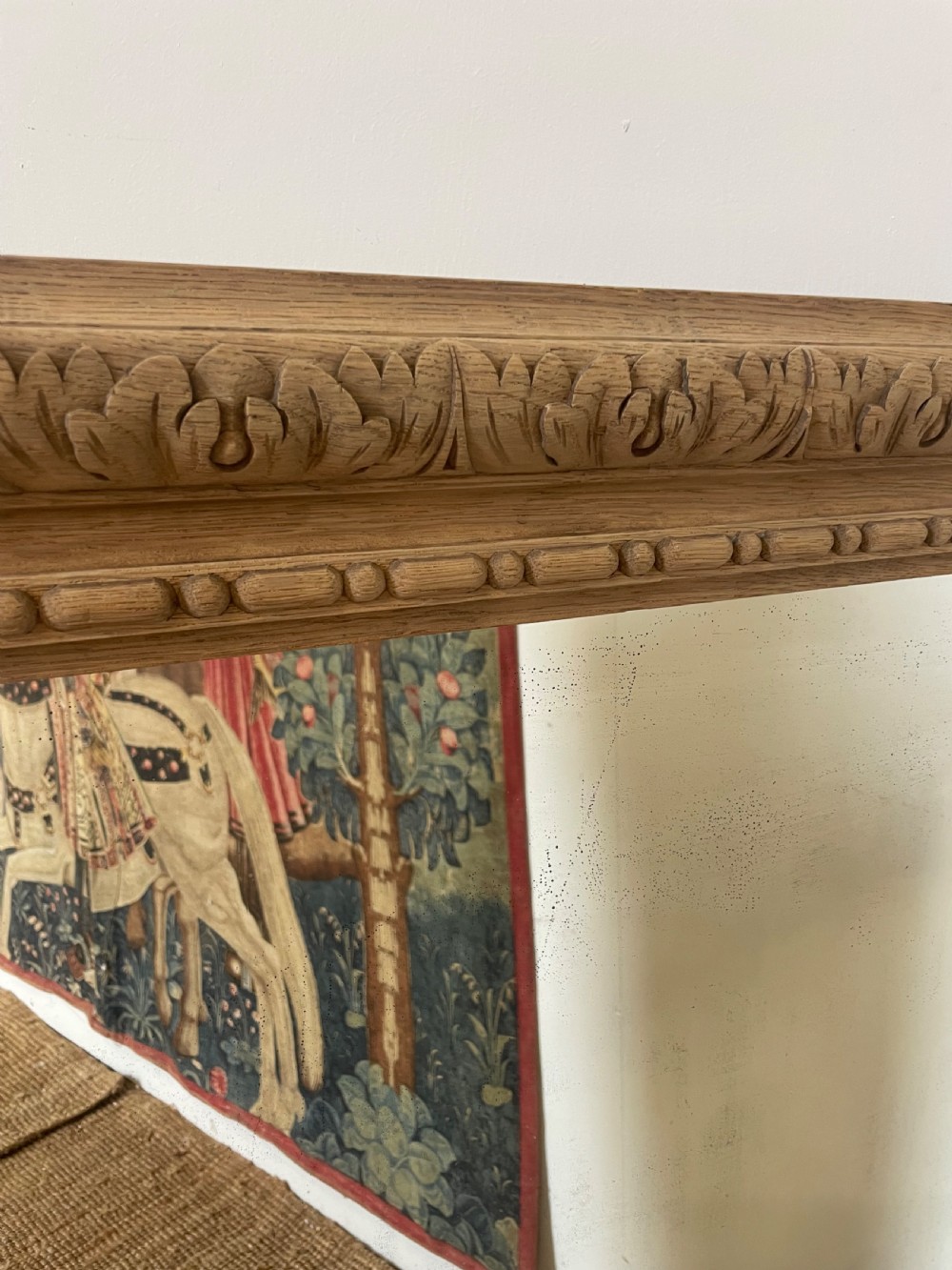 An upright 19th-century carved oak wall mirror with rounded top corners and continuous foliate carved frame detailing. View III