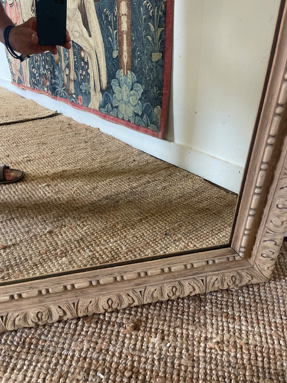 An upright 19th-century carved oak wall mirror with rounded top corners and continuous foliate carved frame detailing. View VI