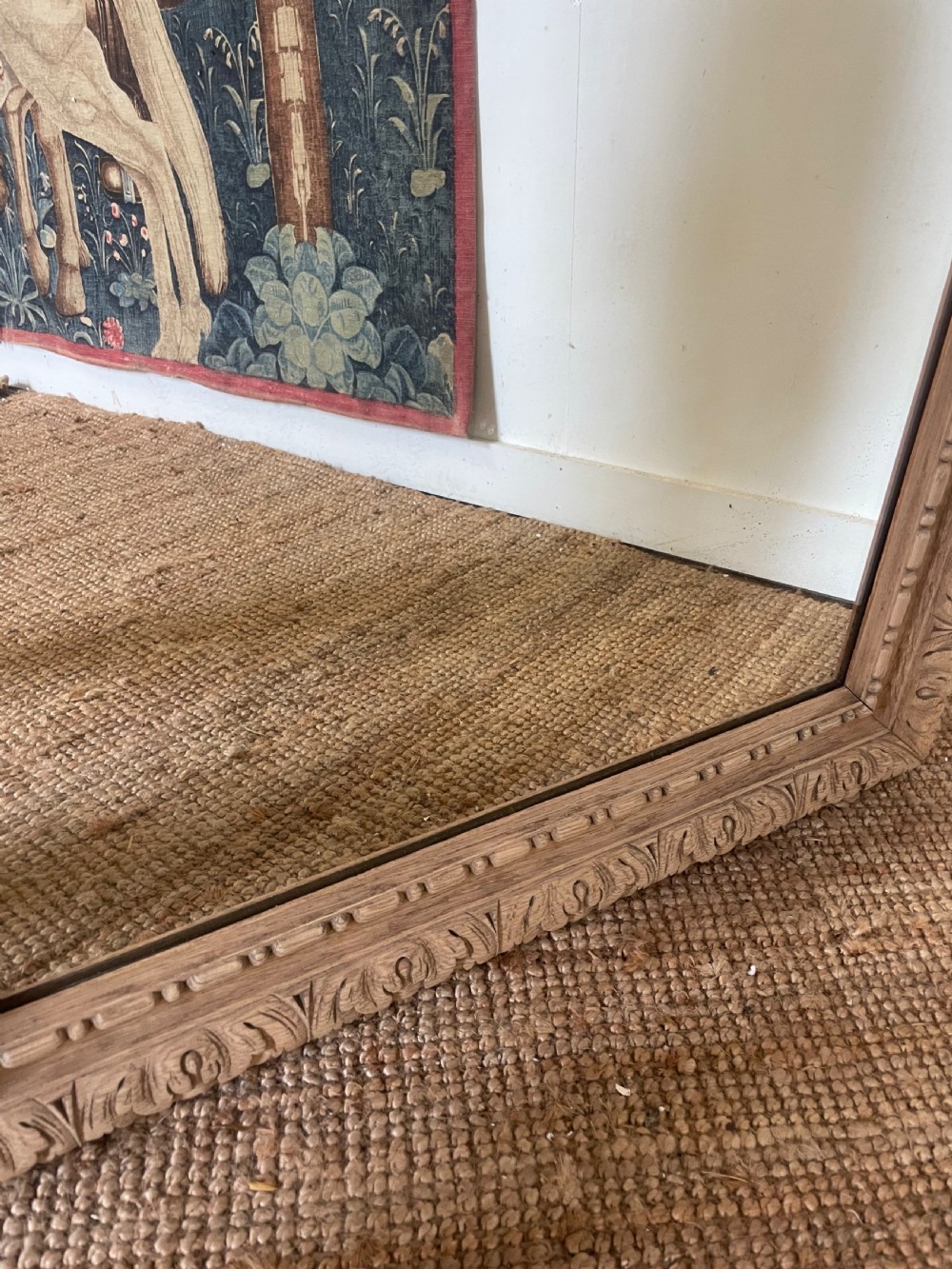 An upright 19th-century carved oak wall mirror with rounded top corners and continuous foliate carved frame detailing. View VII