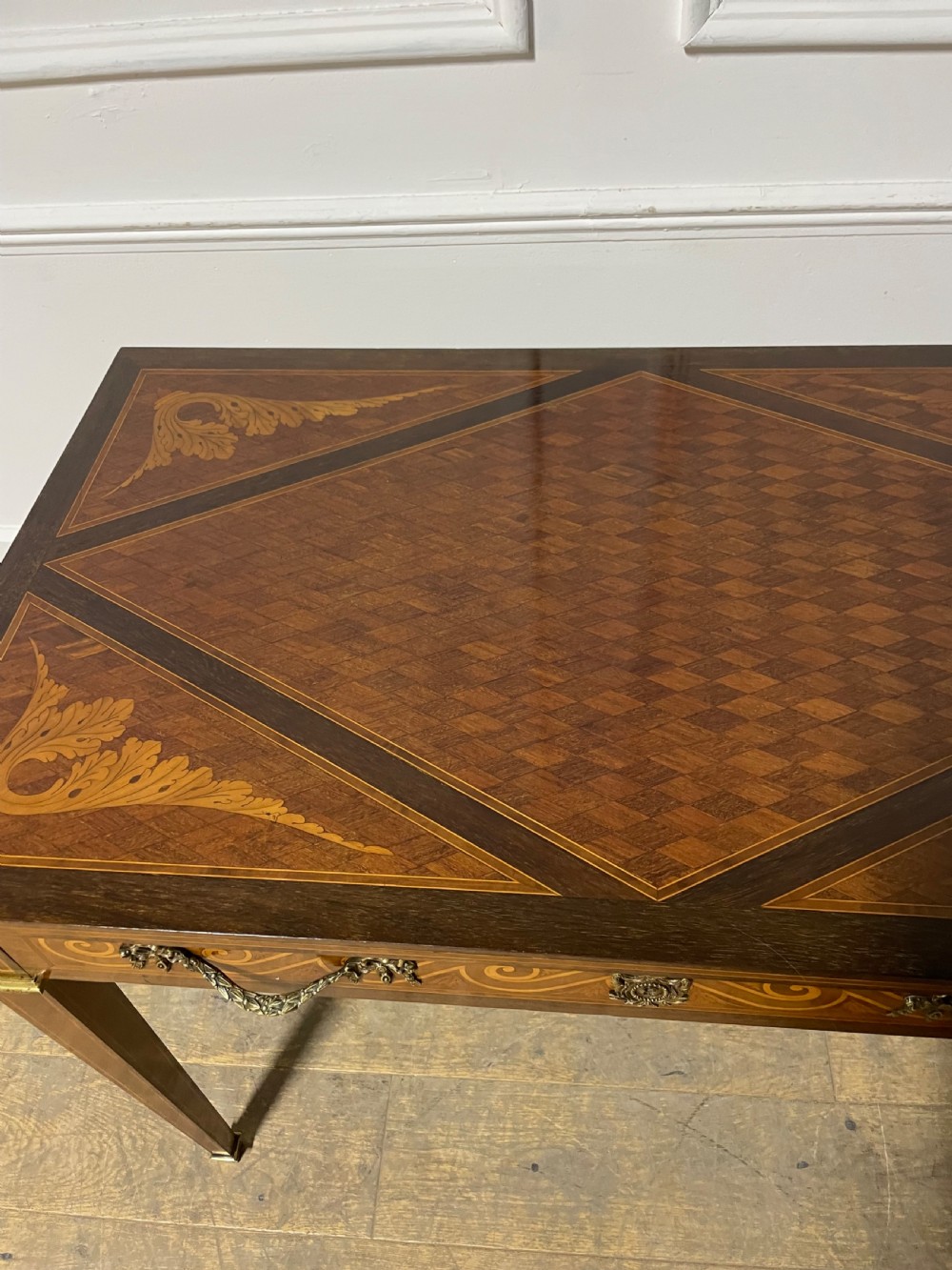 A rectangular antique wooden writing table featuring intricate geometric and floral marquetry on the top and frieze drawer, accented with cast brass mounts and tapering legs. View XIV