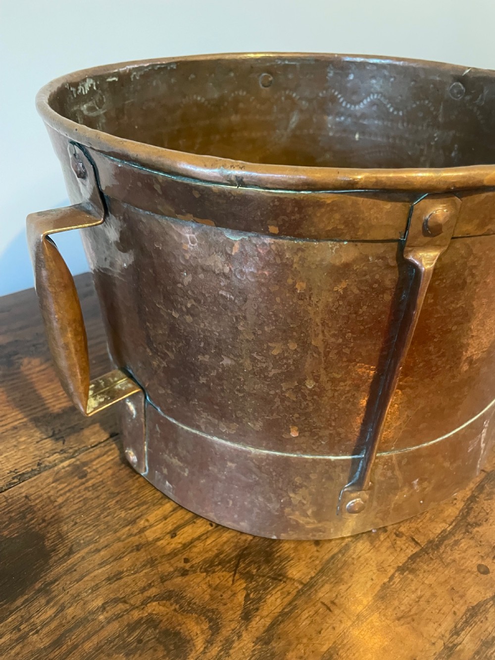 Nineteenth-century hand-hammered copper ferrat bucket featuring riveted vertical support straps and twin side handles. View IV