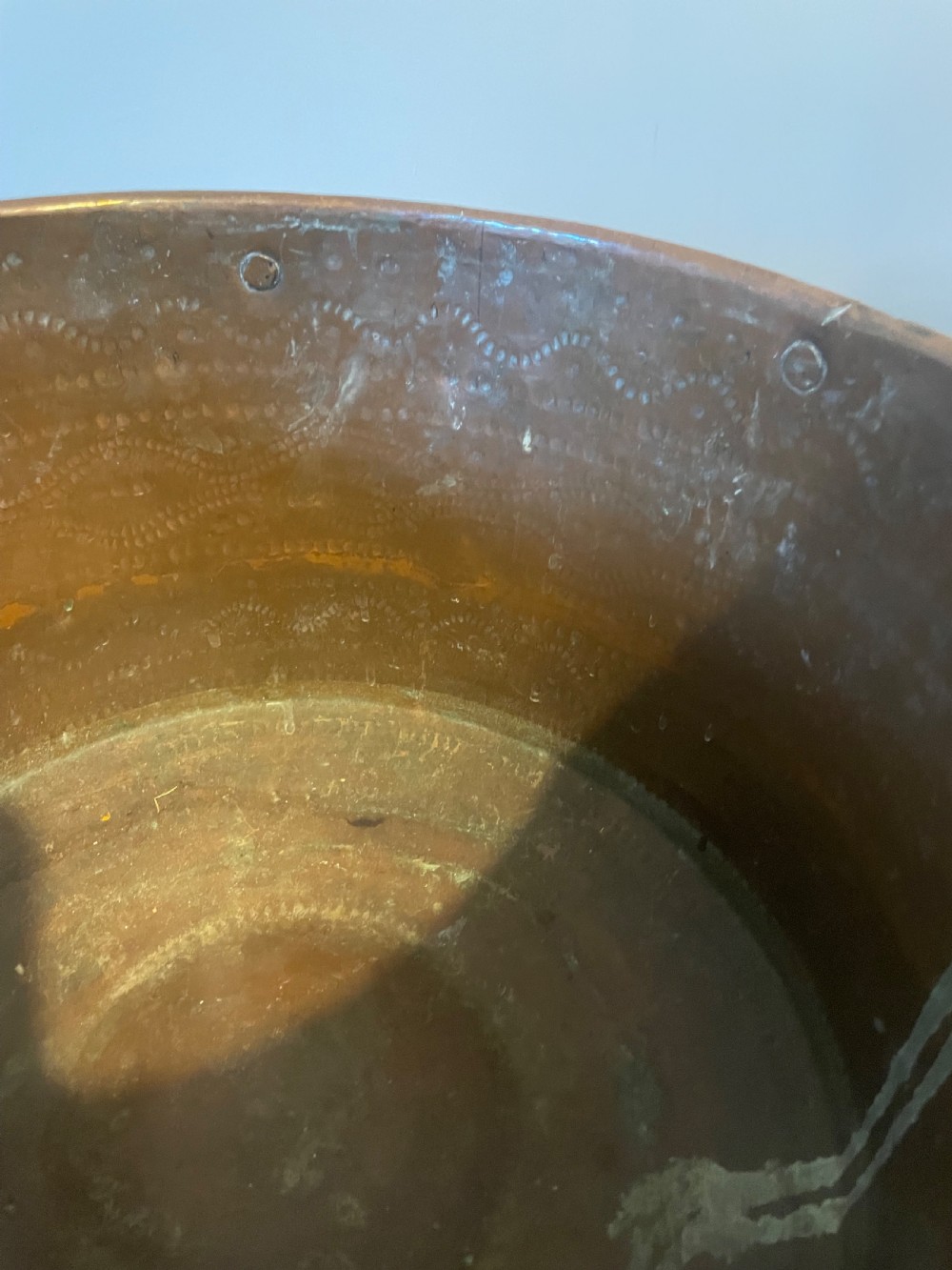 Nineteenth-century hand-hammered copper ferrat bucket featuring riveted vertical support straps and twin side handles. View V