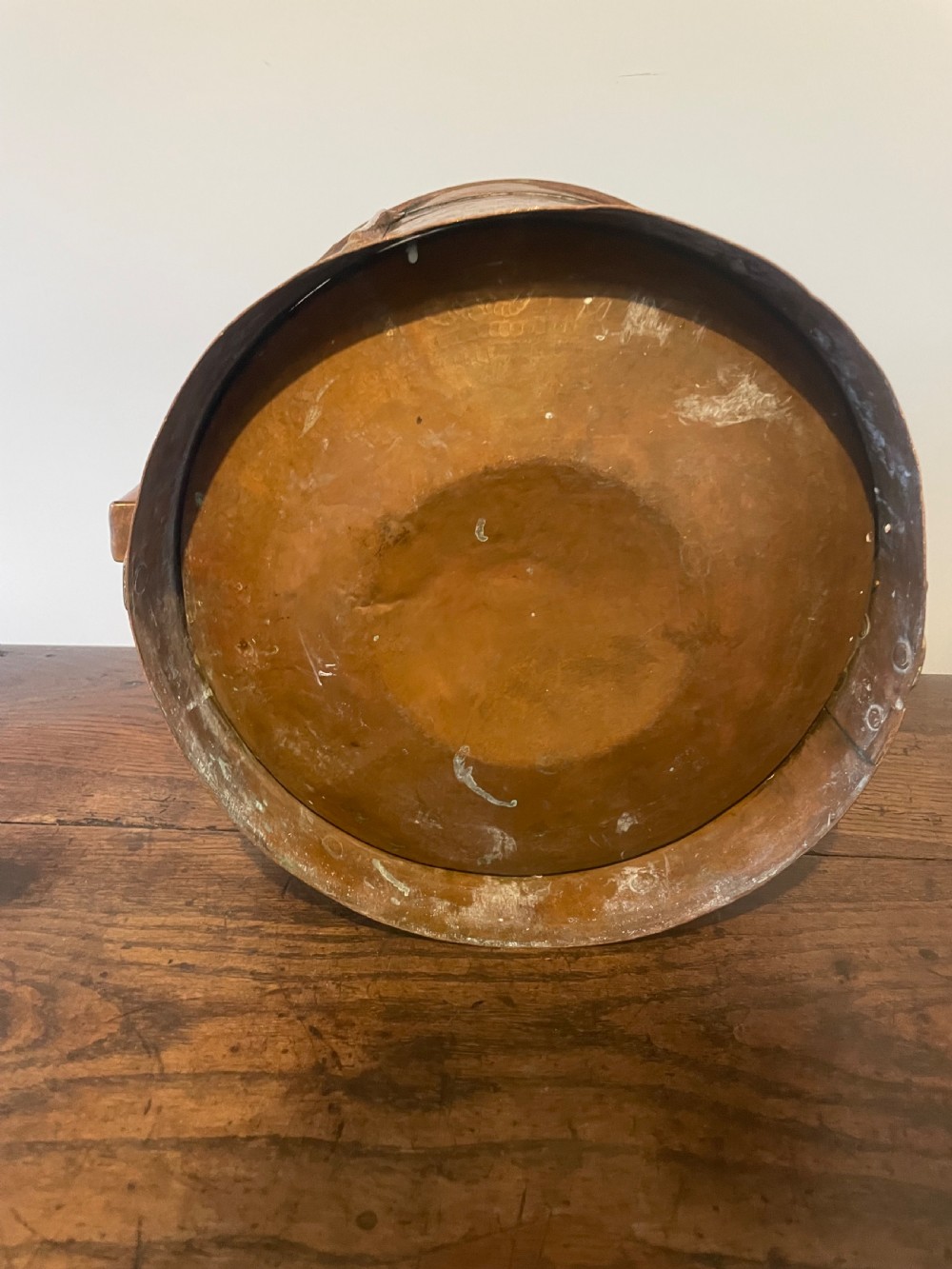 Nineteenth-century hand-hammered copper ferrat bucket featuring riveted vertical support straps and twin side handles. View VI