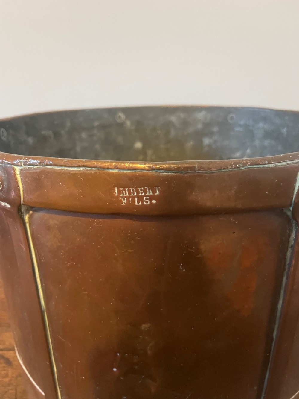 A 19th-century French cylindrical copper bucket featuring riveted vertical reinforcing bands, dual side handles, and a stamped makers mark. View III