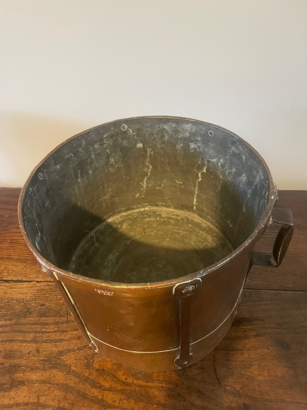 A 19th-century French cylindrical copper bucket featuring riveted vertical reinforcing bands, dual side handles, and a stamped makers mark. View IV