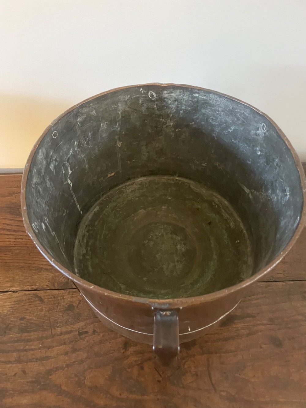 A 19th-century French cylindrical copper bucket featuring riveted vertical reinforcing bands, dual side handles, and a stamped makers mark. View VII